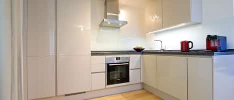 Deluxe Apartment, 2 Bedrooms | Private kitchen | Full-sized fridge, oven, stovetop, dishwasher