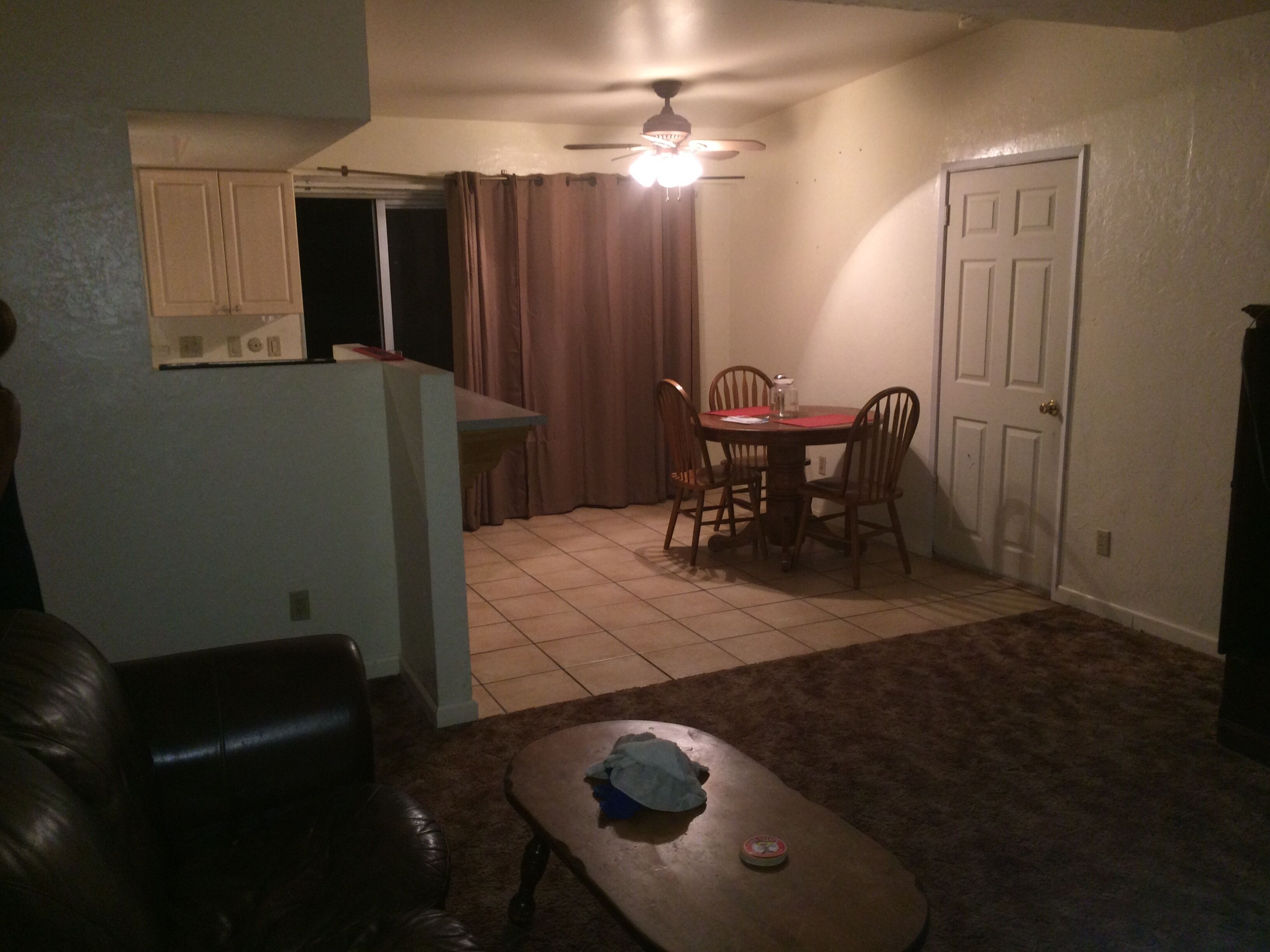 A compact living space with a dining area, a small kitchen, and a seating area.