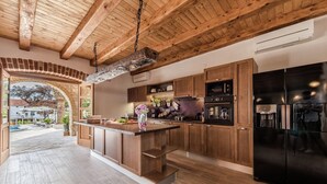 Une cuisine moderne avec des meubles en bois, un îlot central et des appareils électroménagers en acier inoxydable.