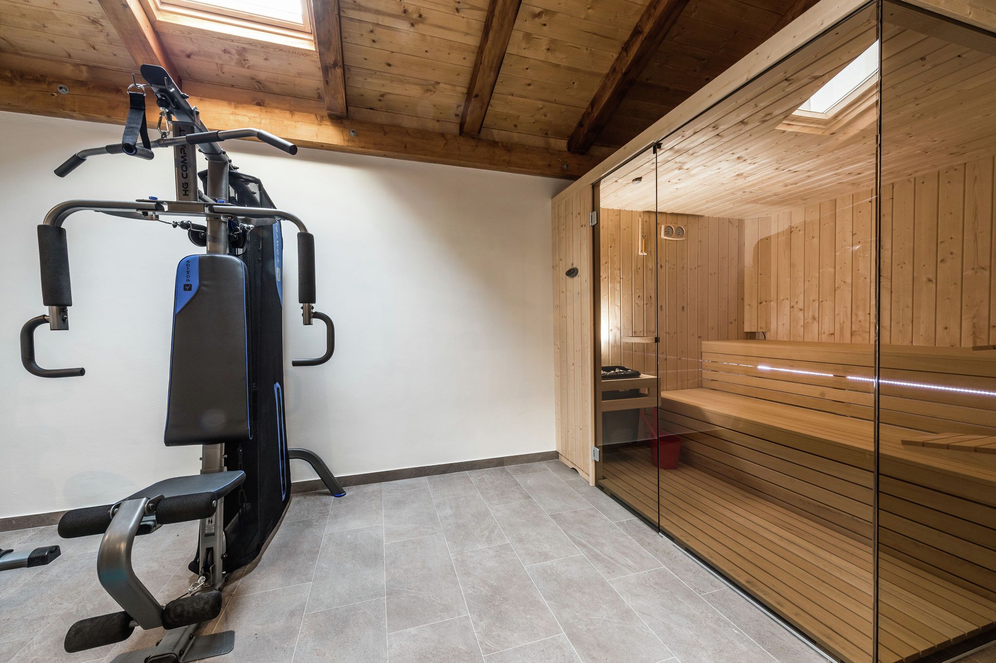 A gym with exercise equipment and a sauna.