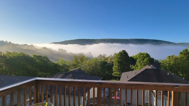 A residential area with houses and a forested hill in the background. - Shenandoah Paradise – Best River & Mountain Views in Harpers Ferry
 (Harpers Ferry)
