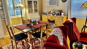 A dining area with a wooden table, red and black tablecloth, and matching chairs. - DOWNTOWN MURPHYS, HALF BLOCK TO MAIN ST (Murphys)