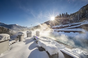 A snow-covered outdoor area with a view of a mountain and a clear sky.
