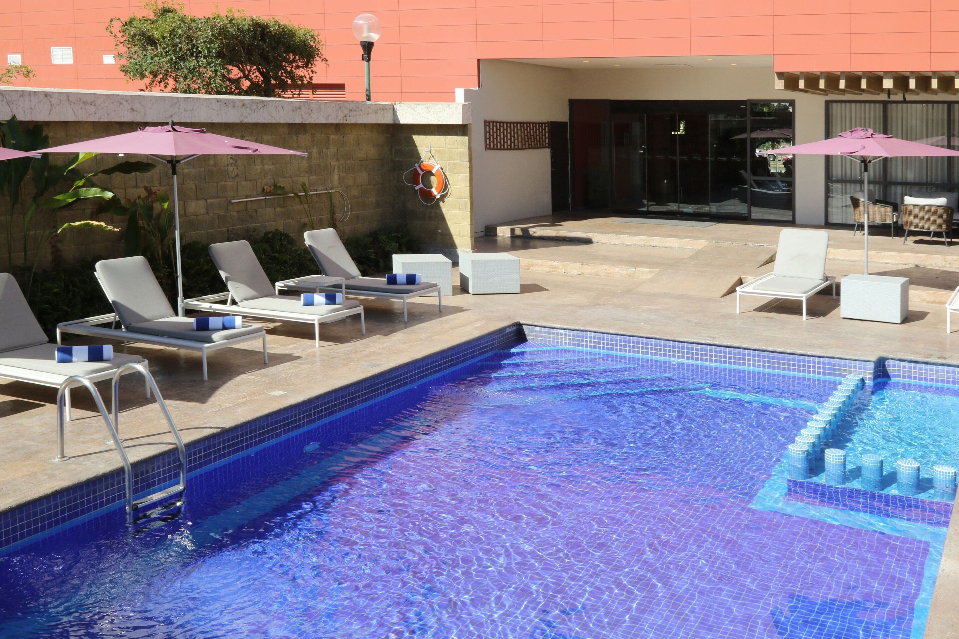 outdoor pool, open 8 am to 9:30 pm, pool umbrellas, pool loungers