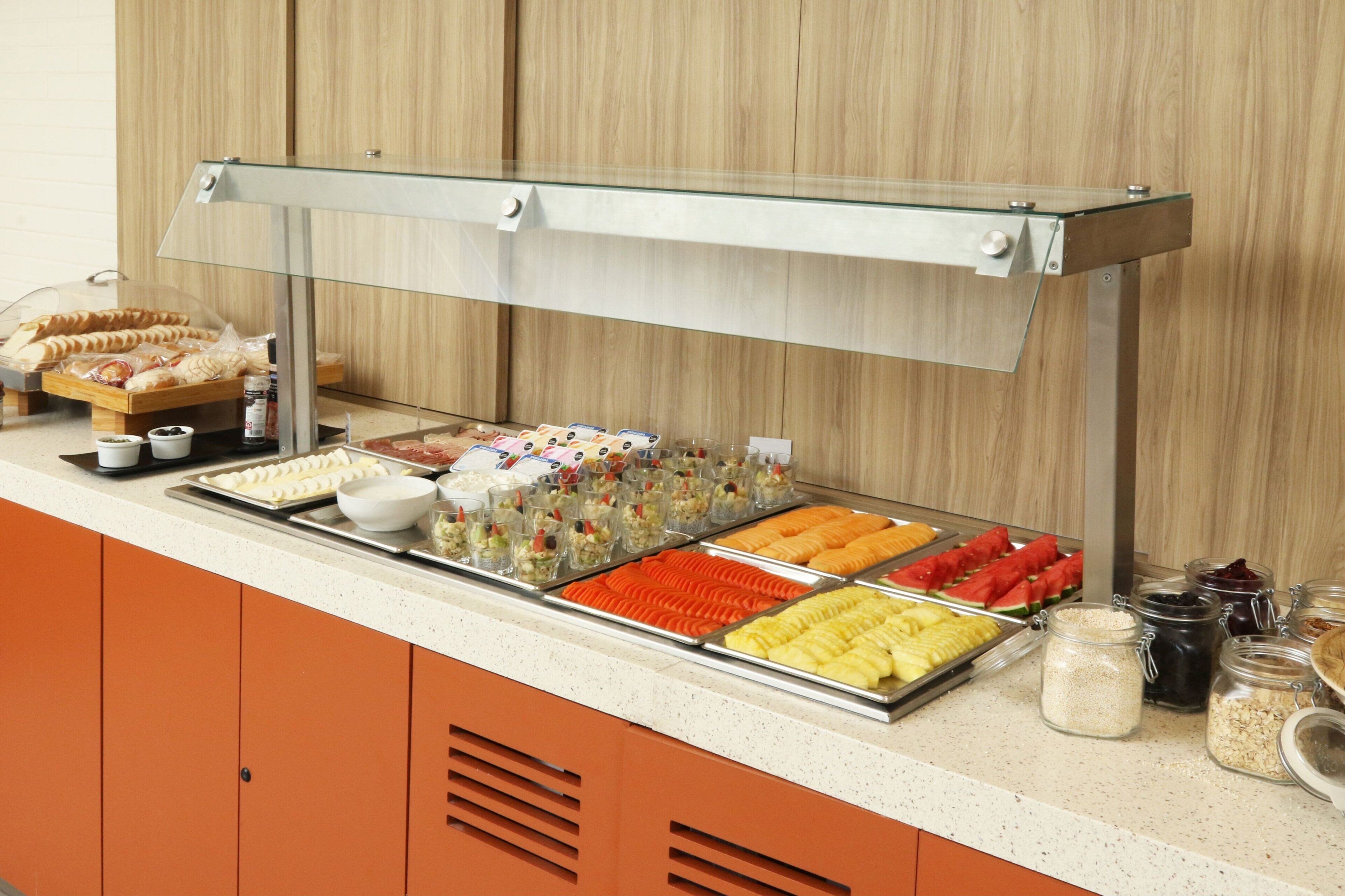 A buffet with various food items and condiments.