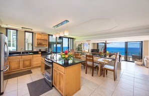Enjoy meals in the spacious kitchen with a large island, ocean view, and dining area for four.