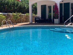 A heated pool, pool loungers