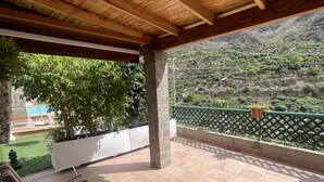 A covered patio with tiled flooring, a wooden ceiling, and a view of a mountainous landscape. - TINO HOUSE - FOR 5 PEOPLE- SWIMMING POOL (Mogán)