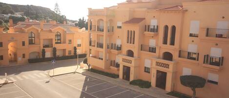 A multi-story building with a uniform architectural style, featuring balconies and a central entrance.