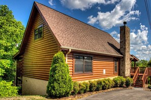 A log cabin with a steeply pitched roof, a chimney, and a small porch with a staircase. - Mountain View Cabin-Pool Table-Hot Tub-Sleeps 8-Near Dollywood-Resort Pool (Sevierville)