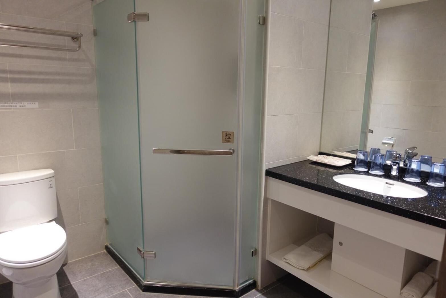 shower, hair dryer, slippers, towels