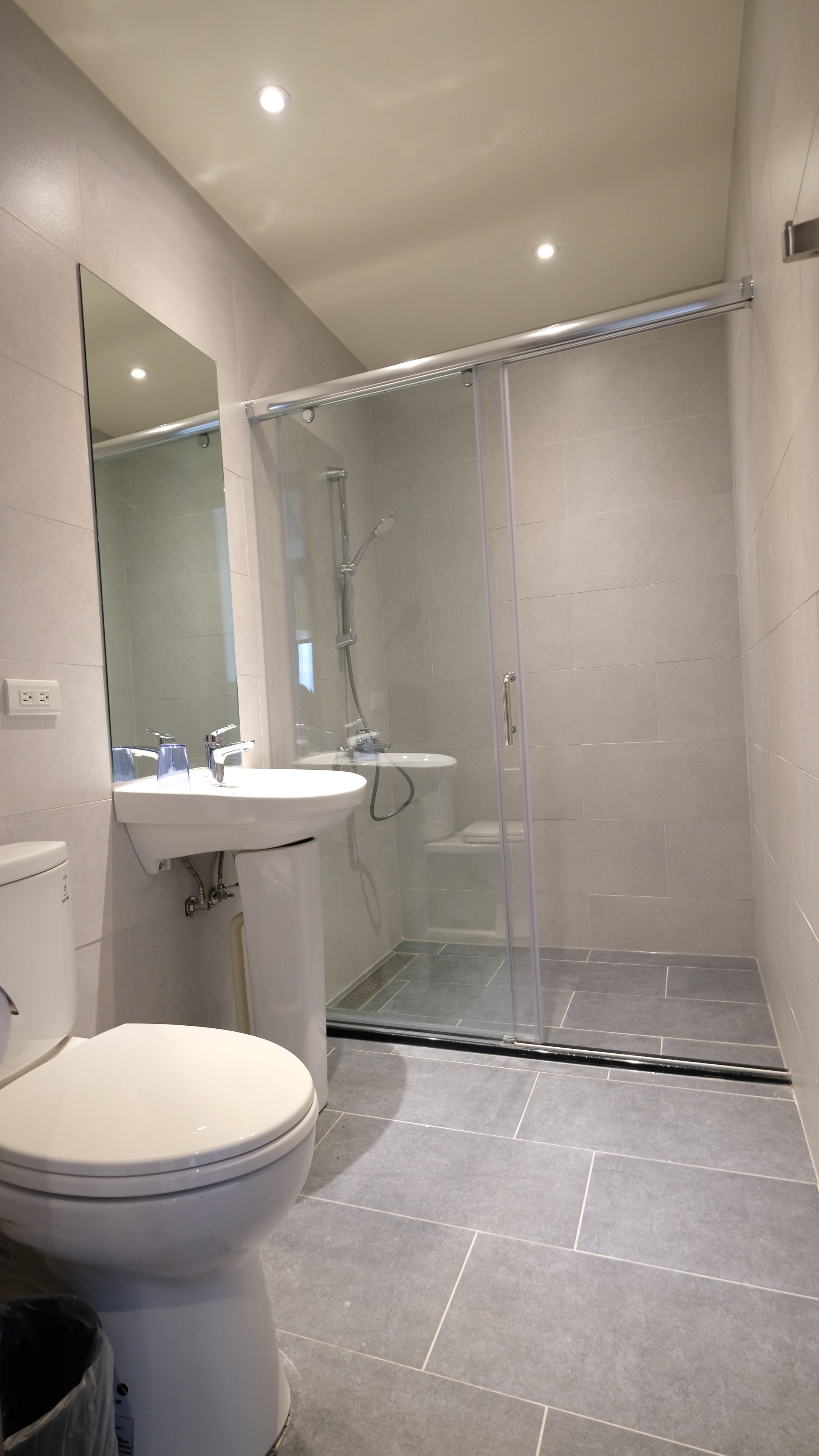 shower, hair dryer, slippers, towels