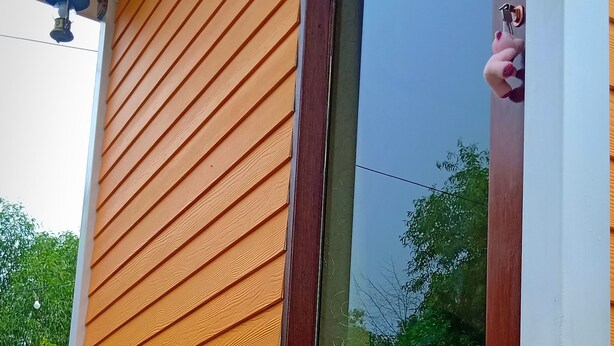 A wooden exterior with a window and a small porch area. - Suansuppachok Inn (Ongkharak)