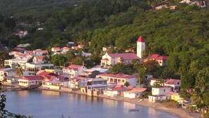 A coastal town with houses, a church, and boats.