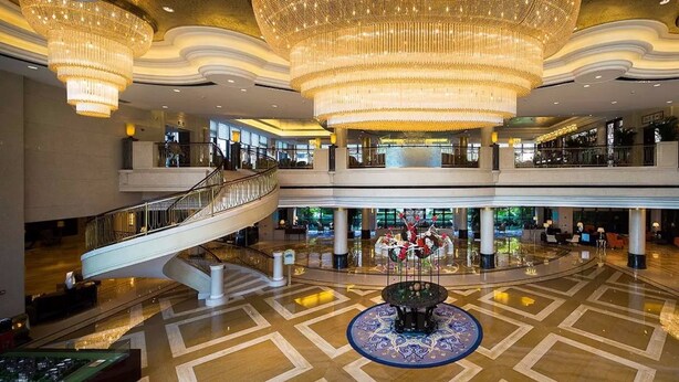 A spacious atrium with a grand chandelier, a central fountain, and a staircase leading to upper levels. - Tongli Lake Resort Phase2 (Suzhou)