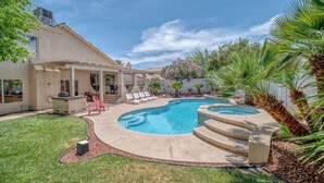 Un jardin avec une piscine, du mobilier de jardin et une maison.