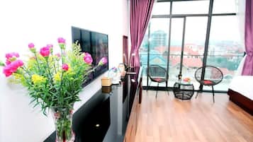 Deluxe Quadruple Room | Living area | 35-inch LCD TV with cable channels, TV