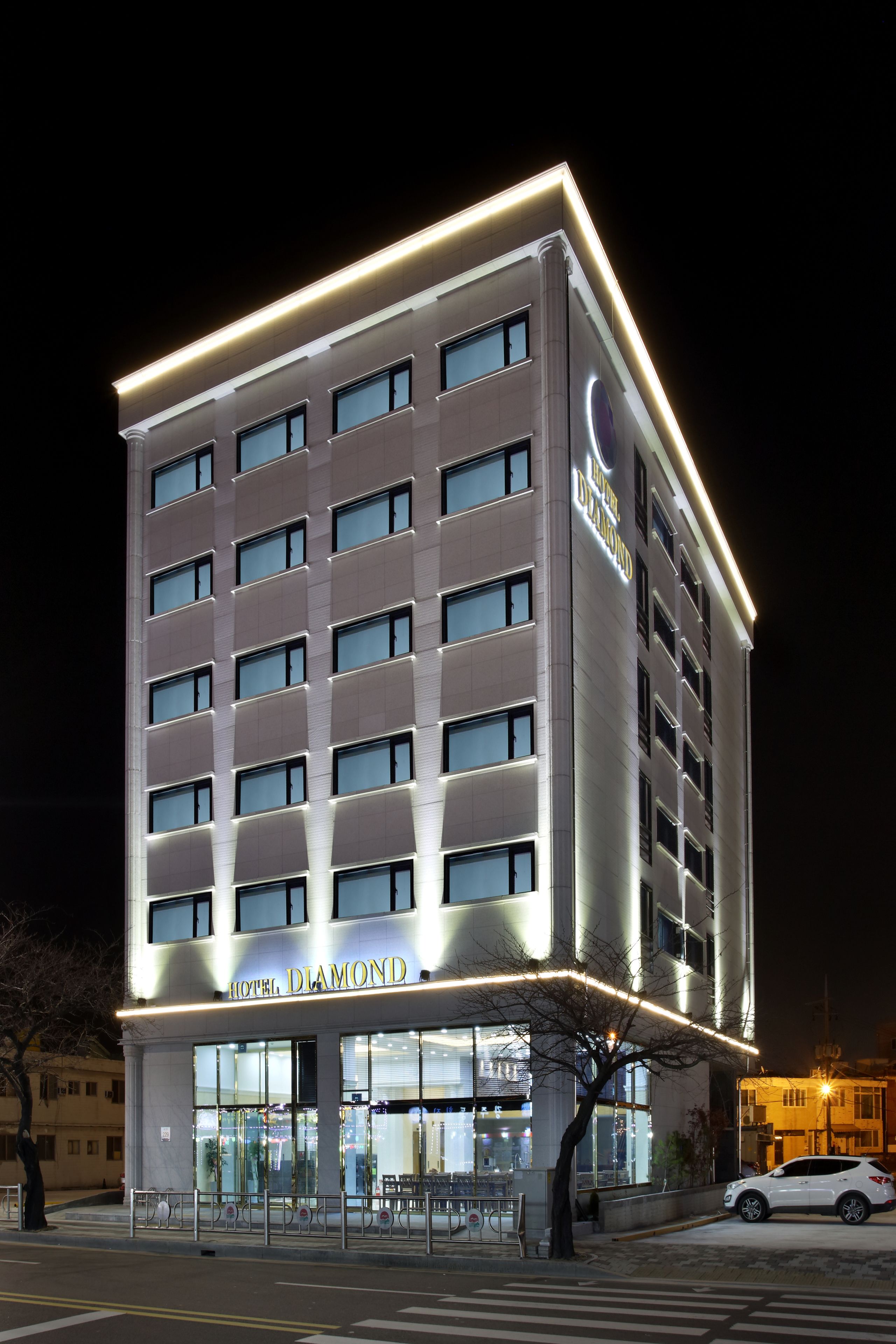 A multi-story hotel with a modern facade and illuminated signage.