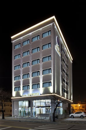 A multi-story hotel with a modern facade and illuminated signage.