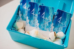 A blue container with cards labeled "Infinity Apartments" and seashells. - Infinity Bophut Apartments (Koh Samui)