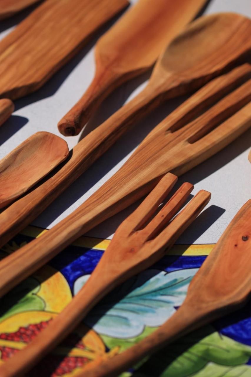 A collection of wooden utensils laid out on a surface.