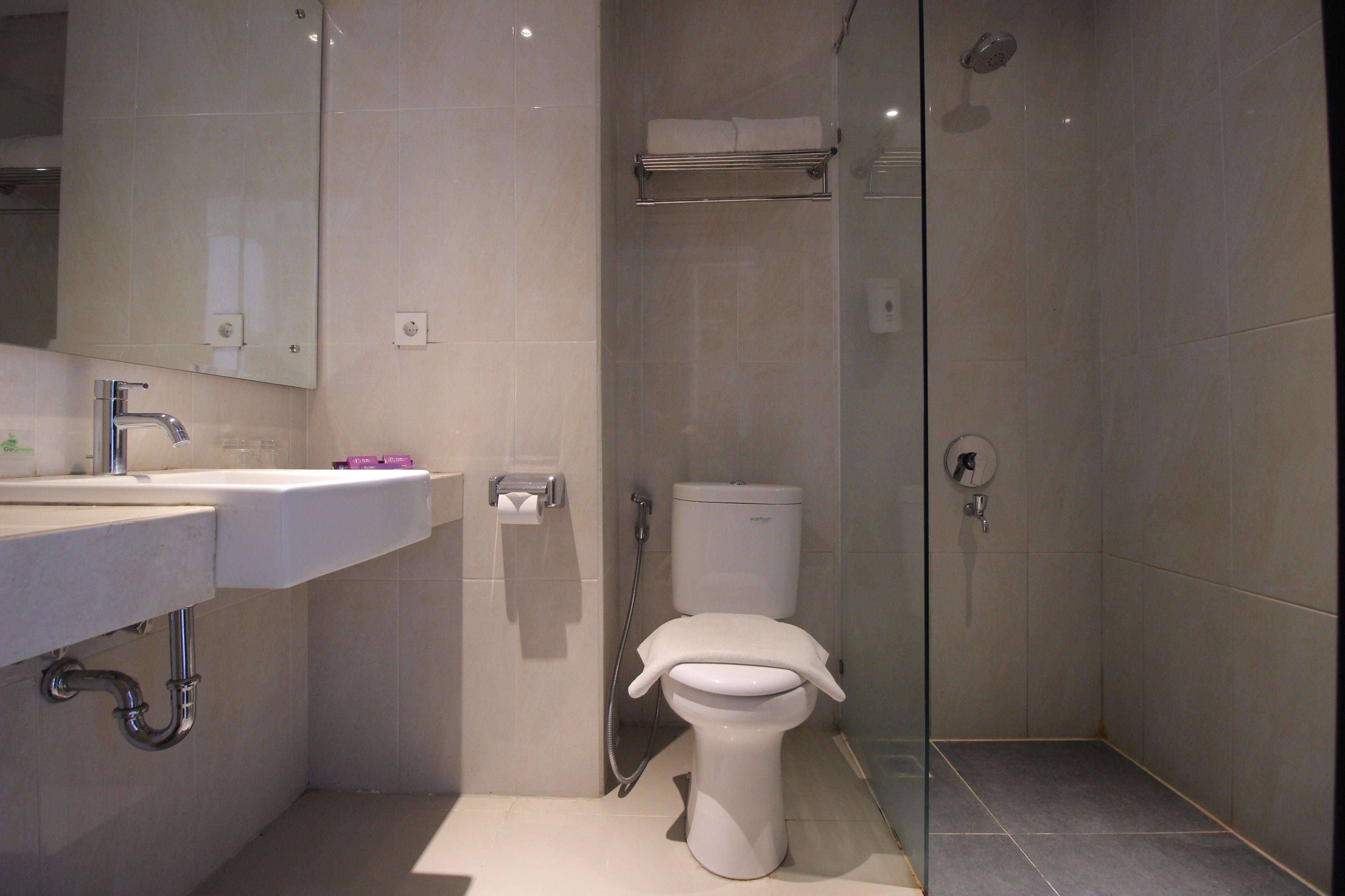 A modern bathroom with a sink, toilet, and shower.