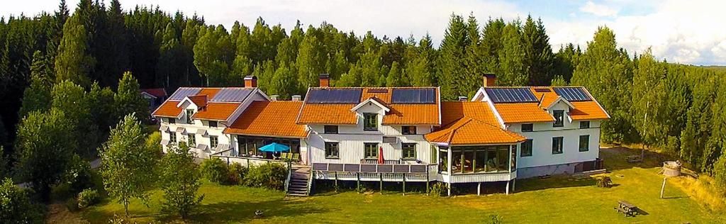 A large house with multiple rooms, surrounded by a forest.
