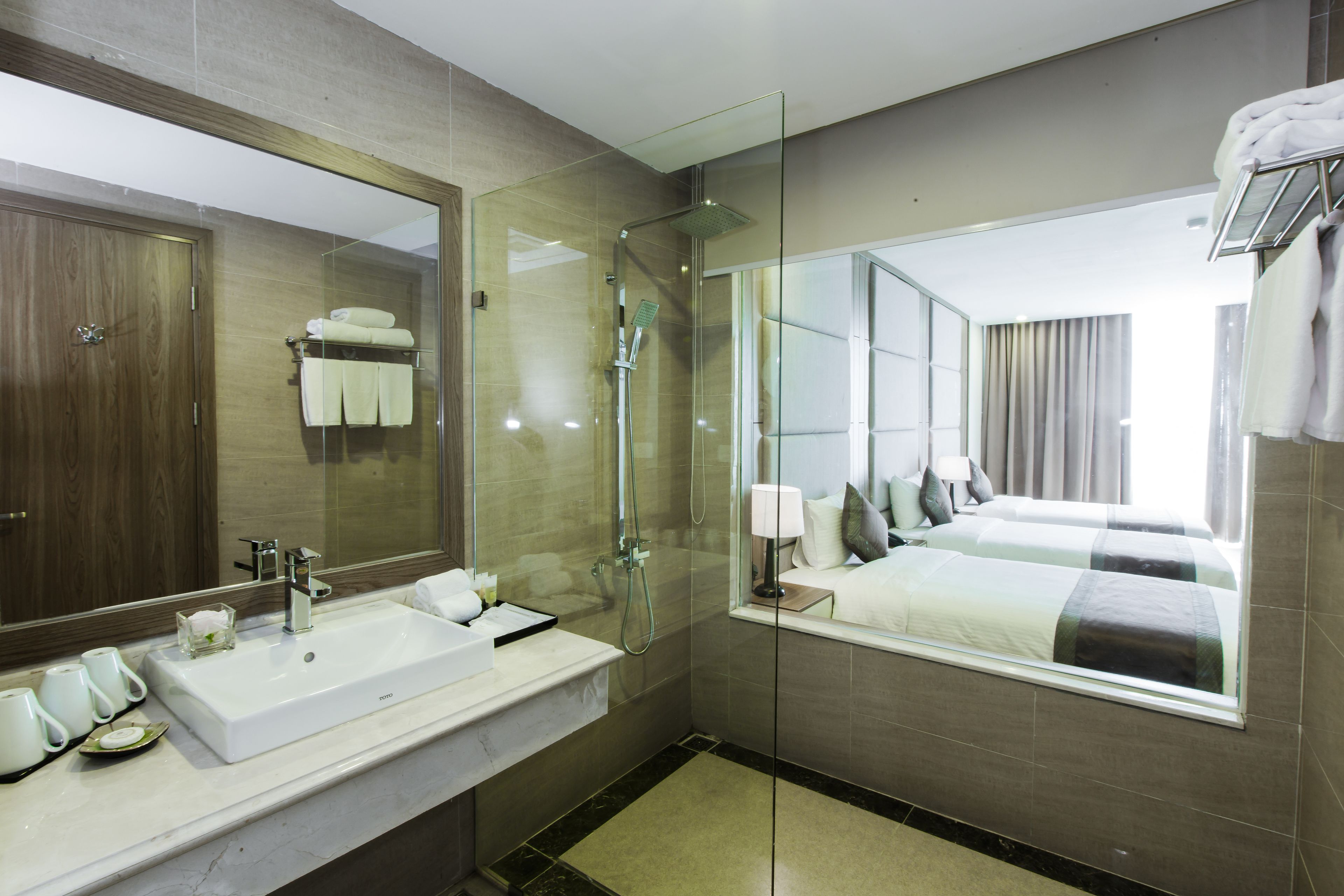 deluxe triple room | bathroom | rainfall showerhead, free toiletries, hair dryer, slippers