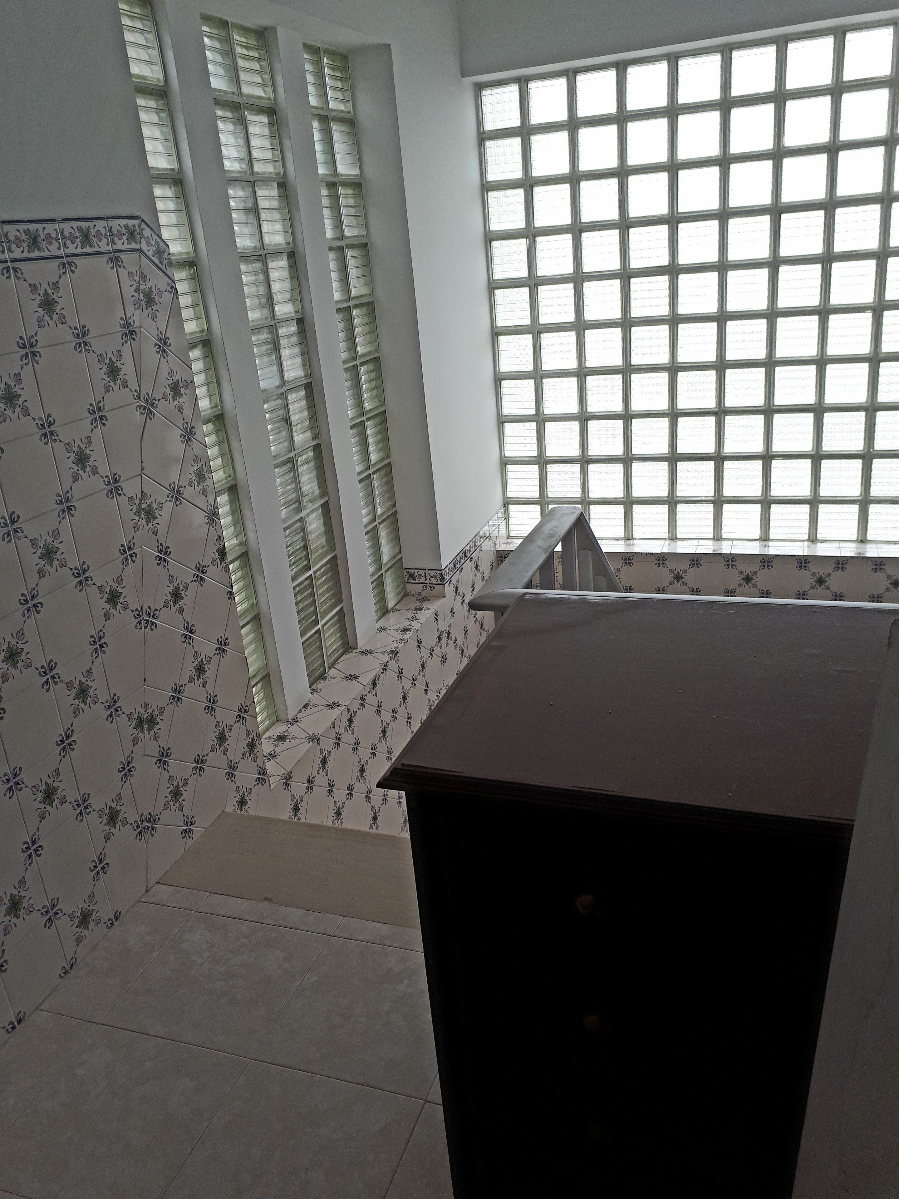 A staircase with patterned tiles leading to a landing.
