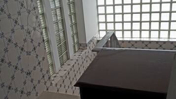 A staircase with patterned tiles leading to a landing.