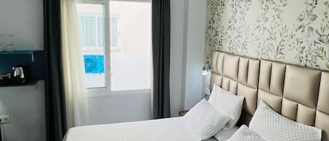 Economy Twin Room | Down comforters, minibar, in-room safe, desk