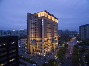 A multi-story hotel with a classical architectural style, featuring a prominent dome and columns at the entrance. - Highton International (Shanghai)