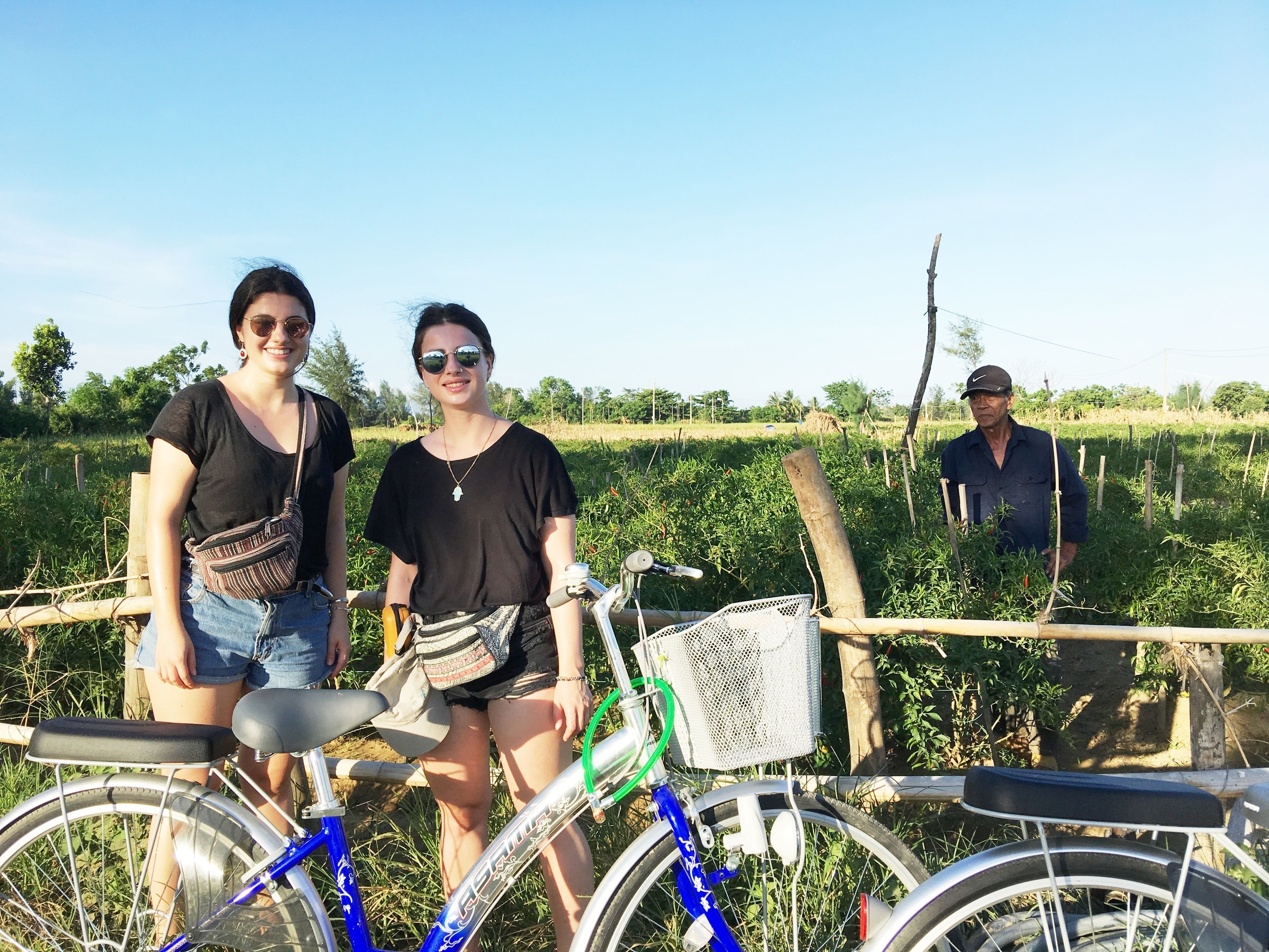 A rural setting with a bicycle and a person standing in the background.
