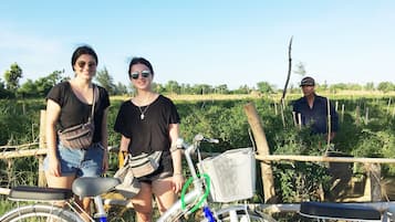 A rural setting with a bicycle and a person standing in the background.