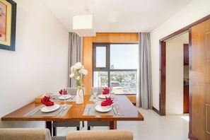 Deluxe Apartment | Living area | 32-inch flat-screen TV with cable channels, TV