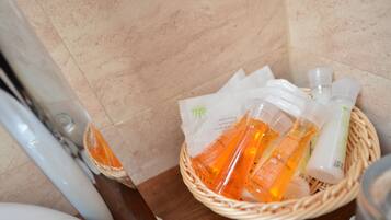 A bathroom with a wicker basket containing toiletries.
