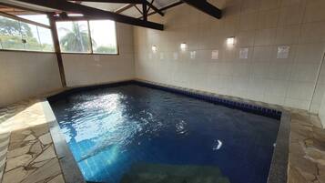 Swim laps in the pool surrounded by natural light and views of the surrounding area.