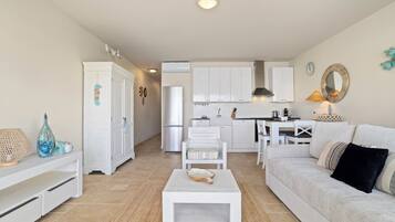 Deluxe Apartment, 1 Queen Bed | Living area | 50-inch Smart TV with cable channels, TV, pay movies