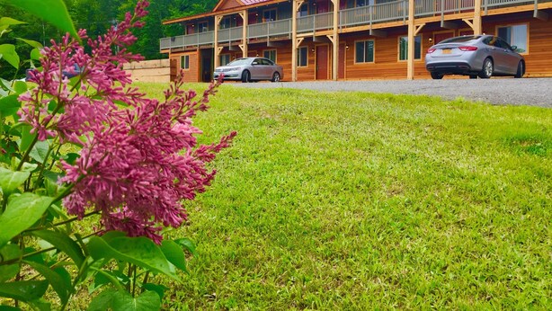 A lodge with a two-story structure, multiple balconies, and a gravel driveway.