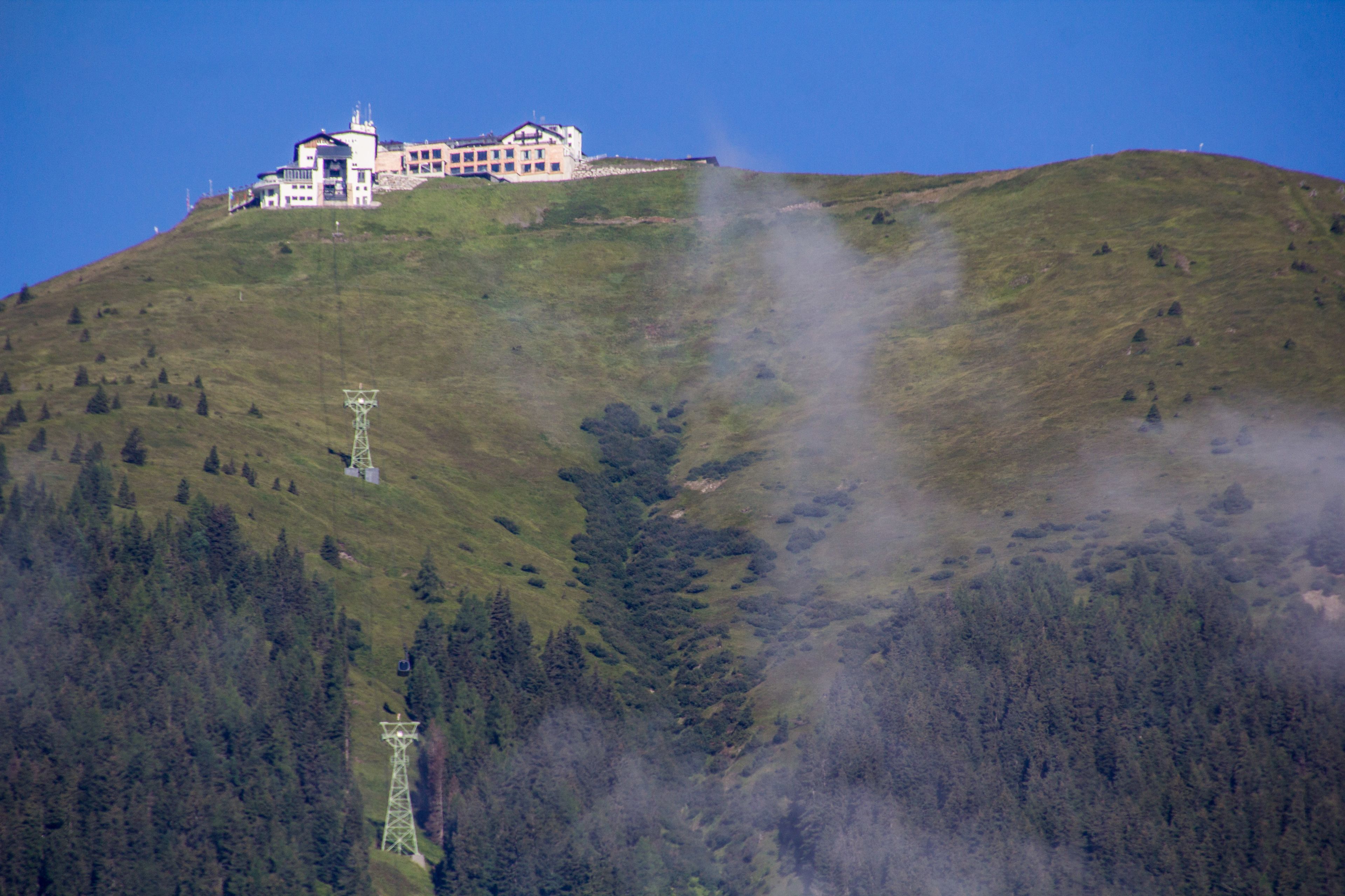 Un grand bâtiment perché sur une colline, sous un ciel dégagé.