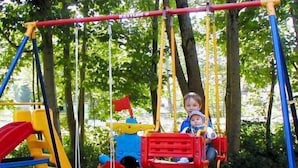 A playground with swings and slides.