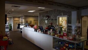 A reception area with a counter, a computer, and various items on display. - Sheldon's Motel by OYO Keysville Near Hwy 360 (Keysville)