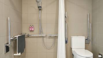 A modern bathroom with a shower, toilet, and towel rack.