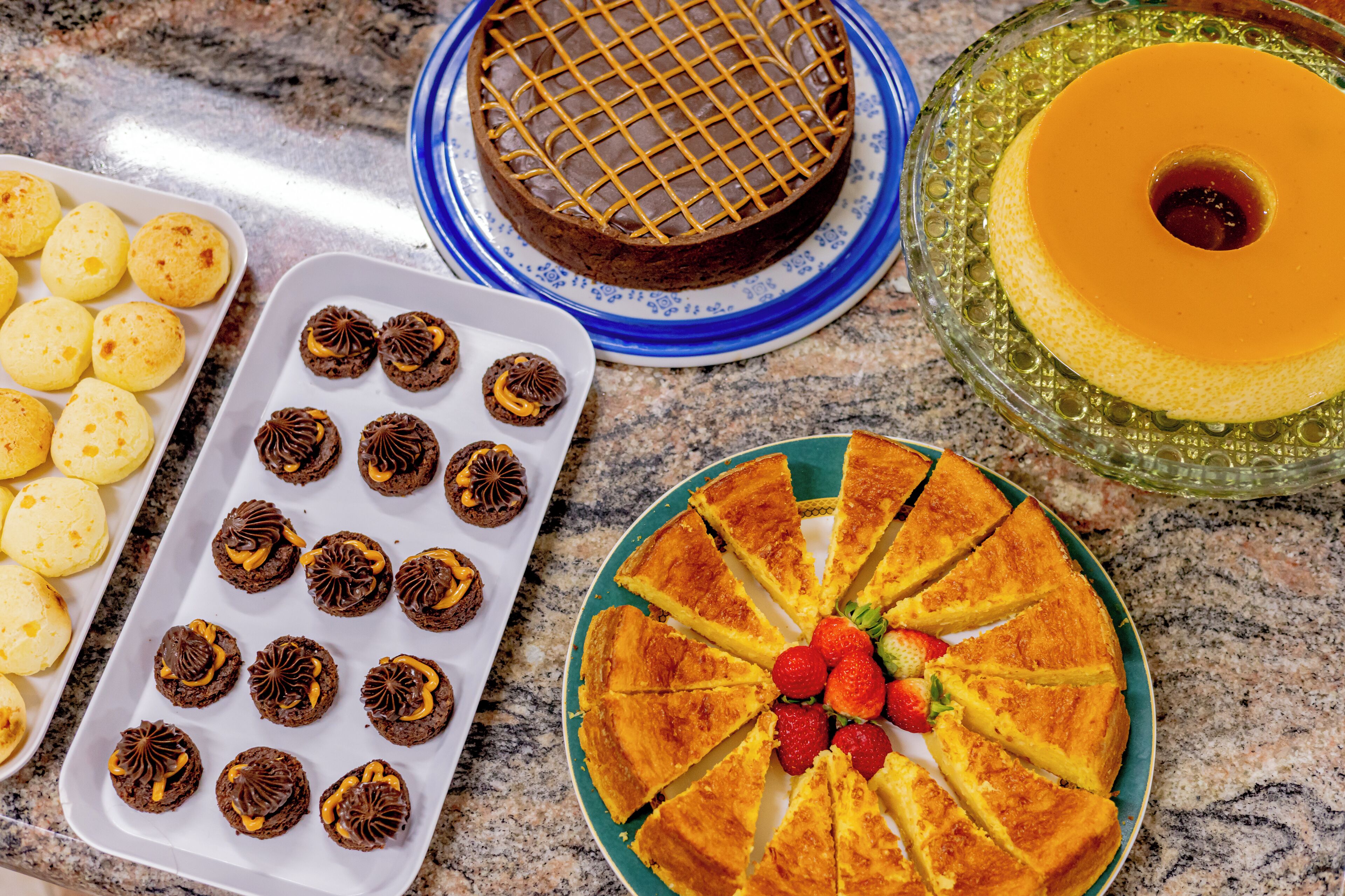 A variety of desserts on a marble countertop.