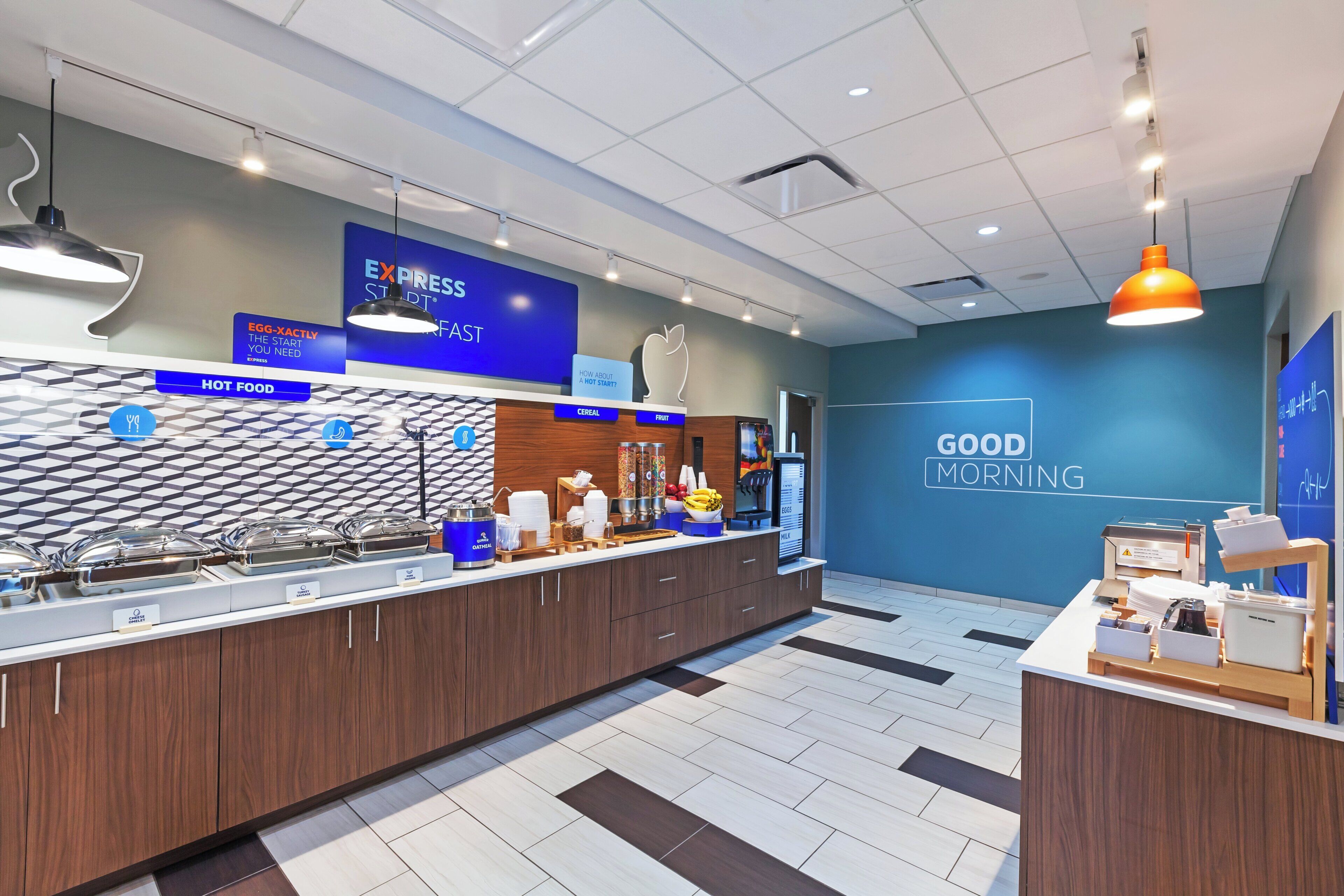 A breakfast buffet area with a variety of food options, including cereal, fruit, and dairy products.