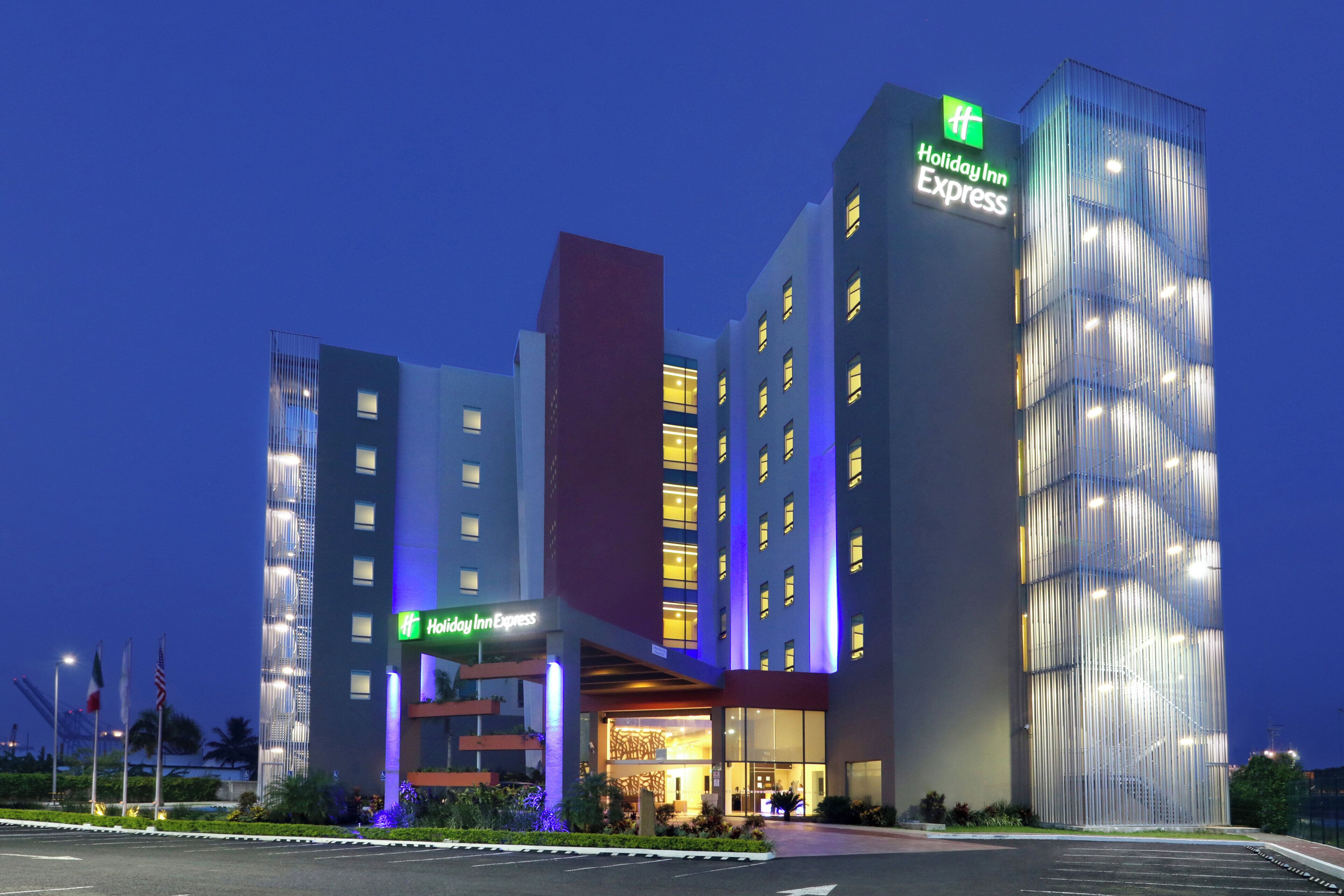 A Holiday Inn Express hotel with a modern design, featuring multiple floors and a prominent entrance.