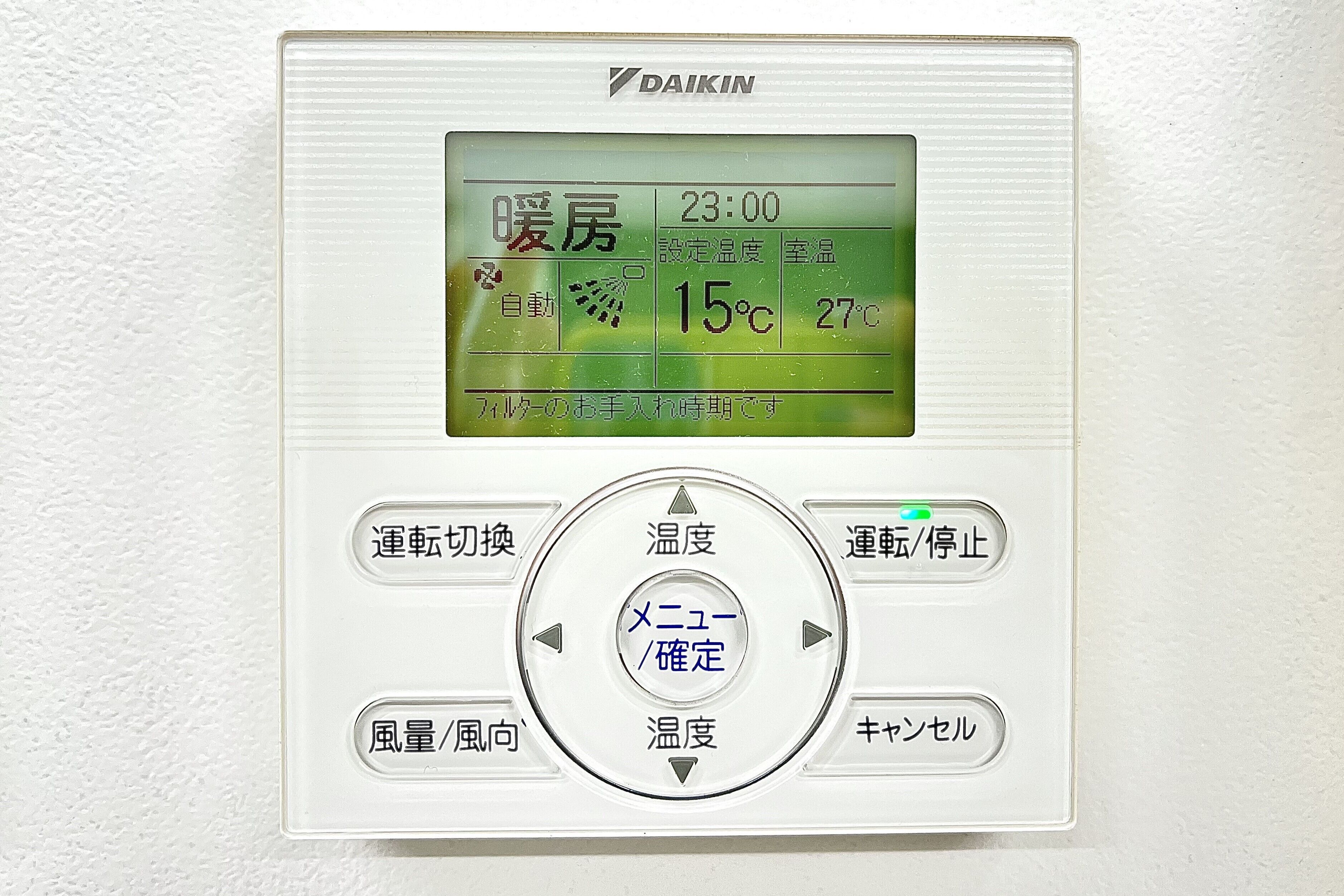 A thermostat with a digital display, control buttons, and a central dial.