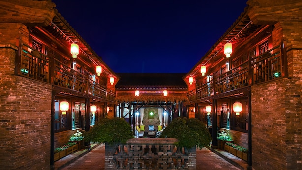 A traditional courtyard with brick walls, lanterns, and a central seating area. - Elsewhere Hotel The former residence of the draft bank (Jinzhong)