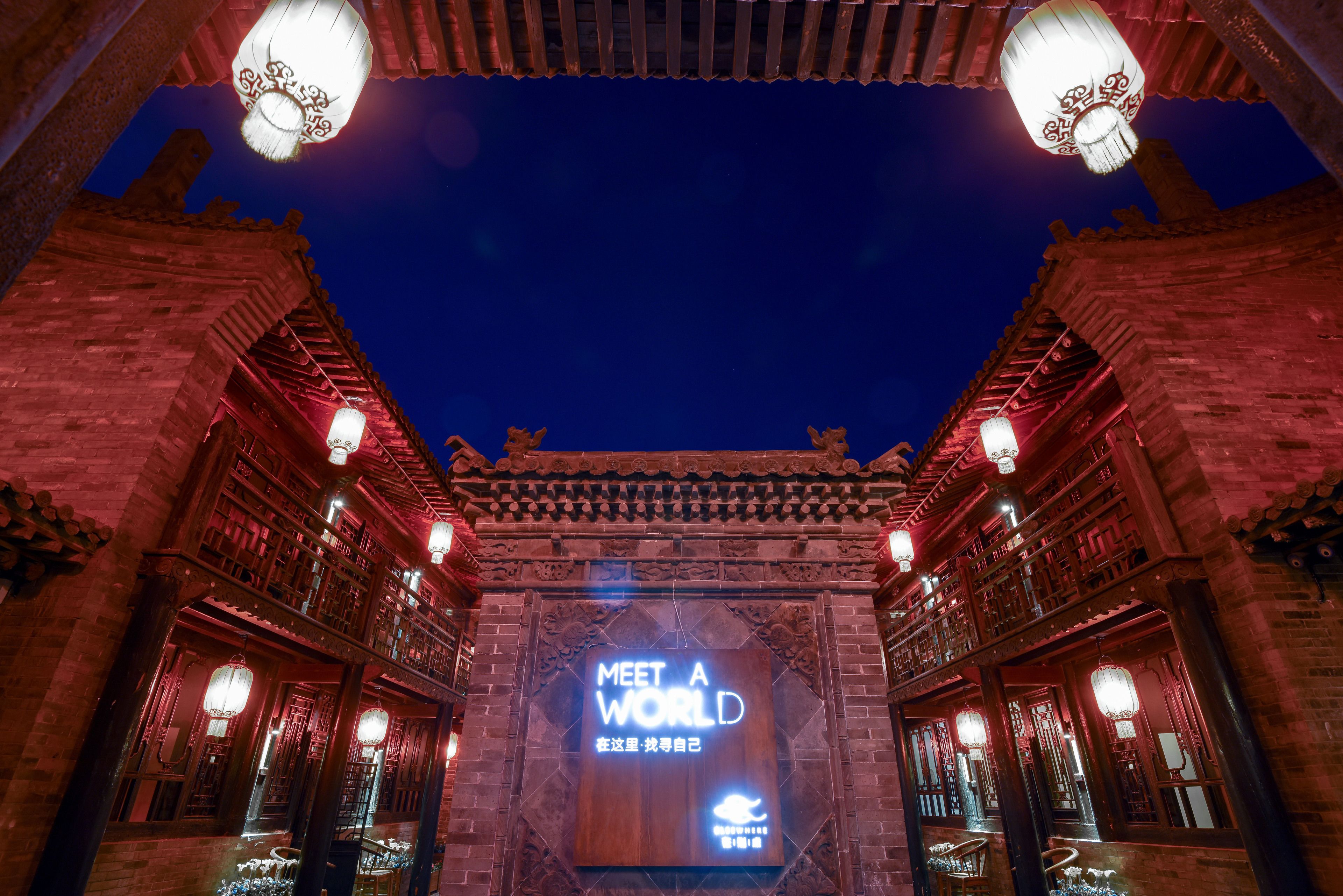 A traditional Chinese building entrance with a 'Meet a World' sign.