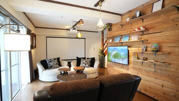 120-inch flat-screen TV with cable channels, video-game console, Netflix